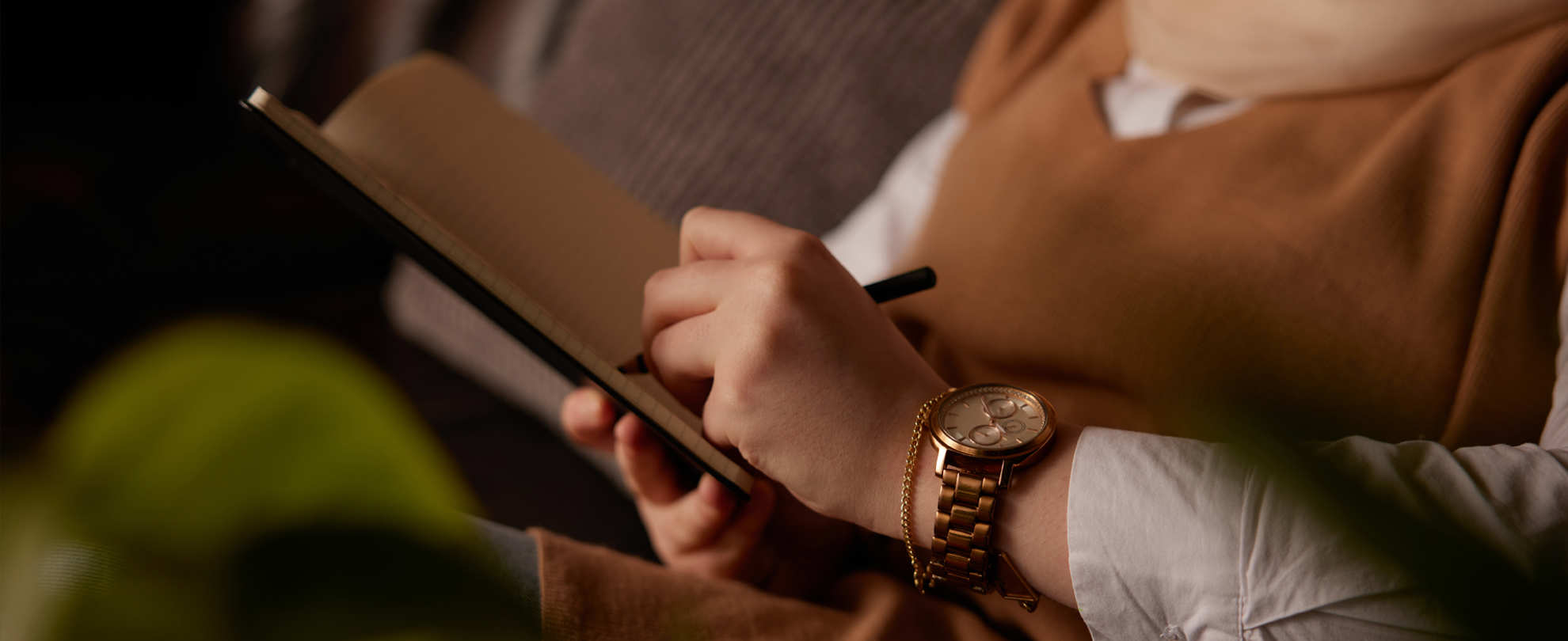 A person writing in a notebook.