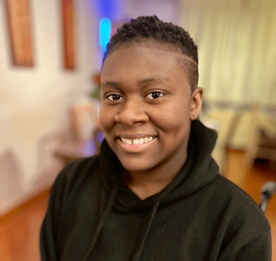 Portrait of Simi smiling.