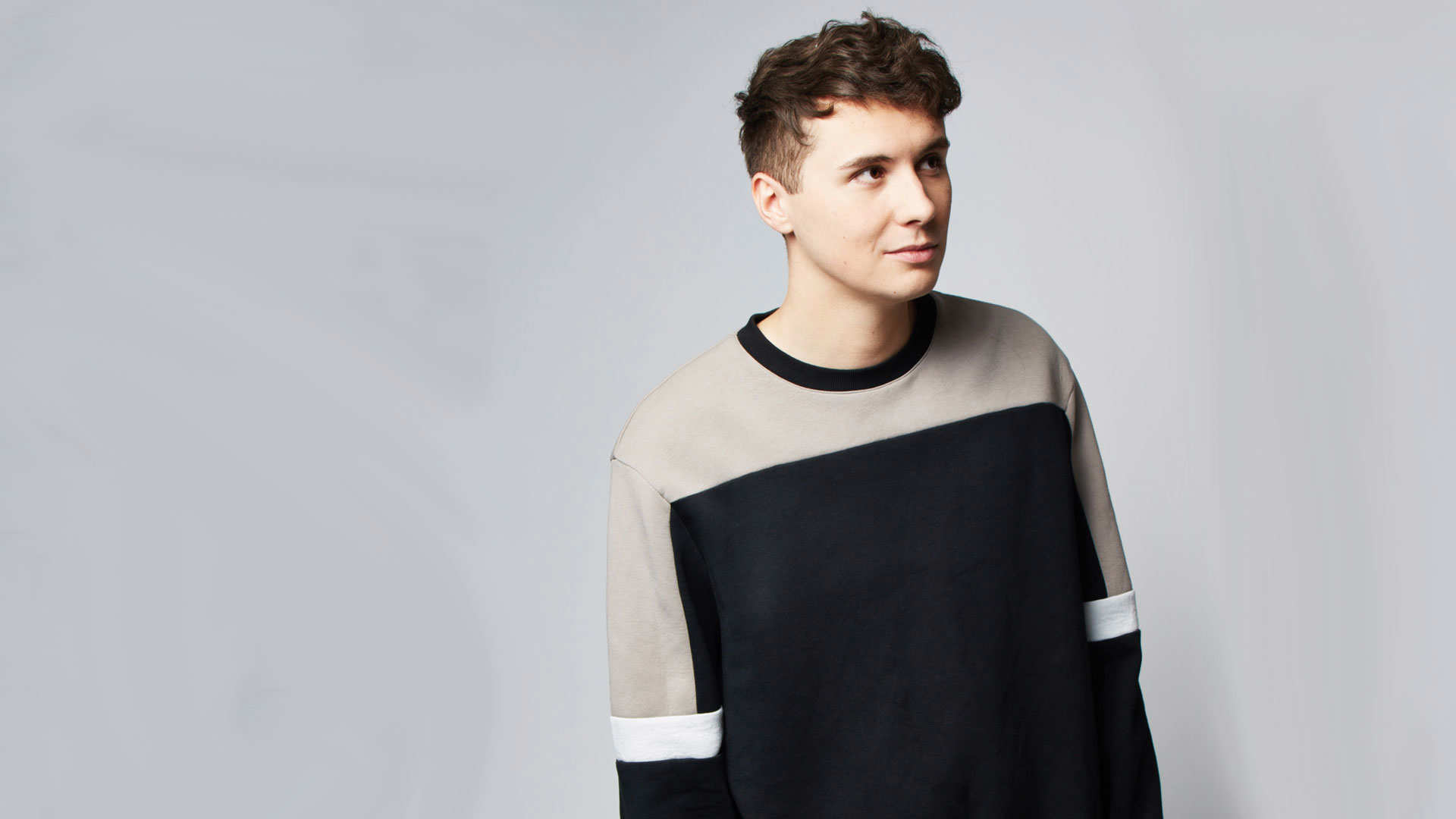 Headshot of Dan Howell against a light grey background