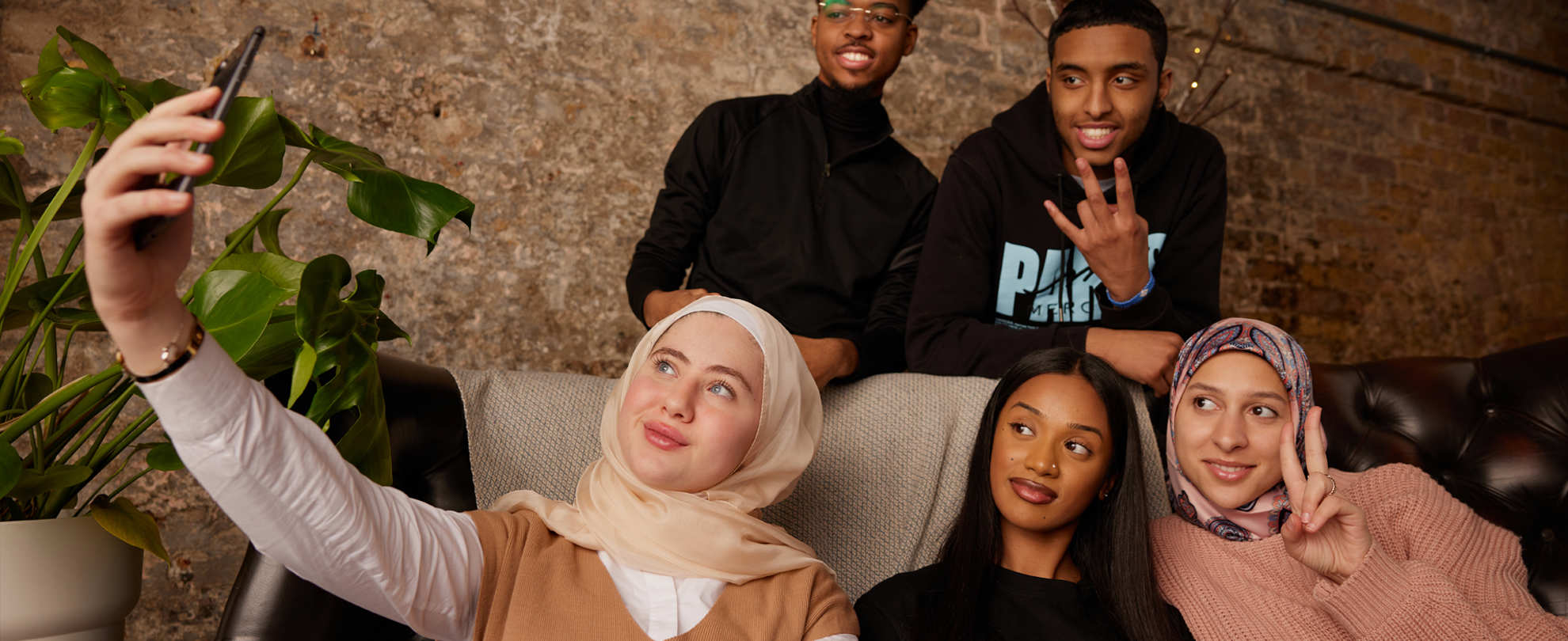 A group of people taking a selfie.