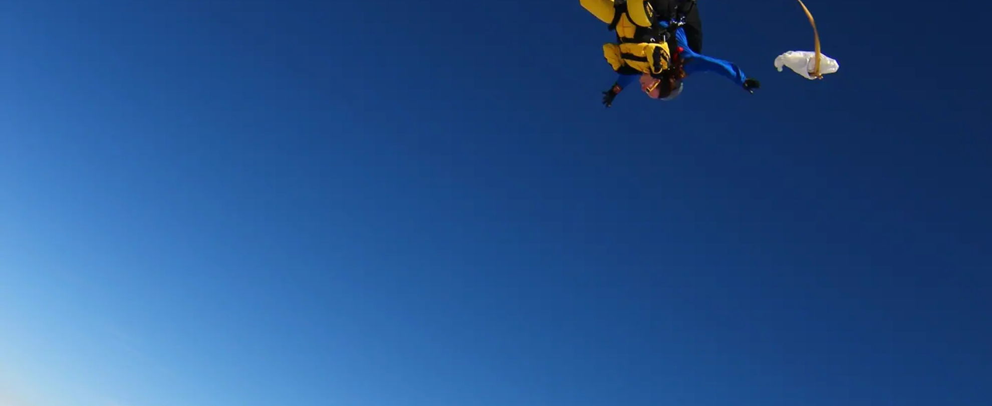 Our fundraiser Laura skydiving above the clouds.