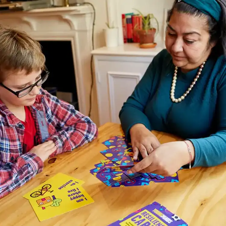 Mother and son playing with the YoungMinds resilience card primary pack.
