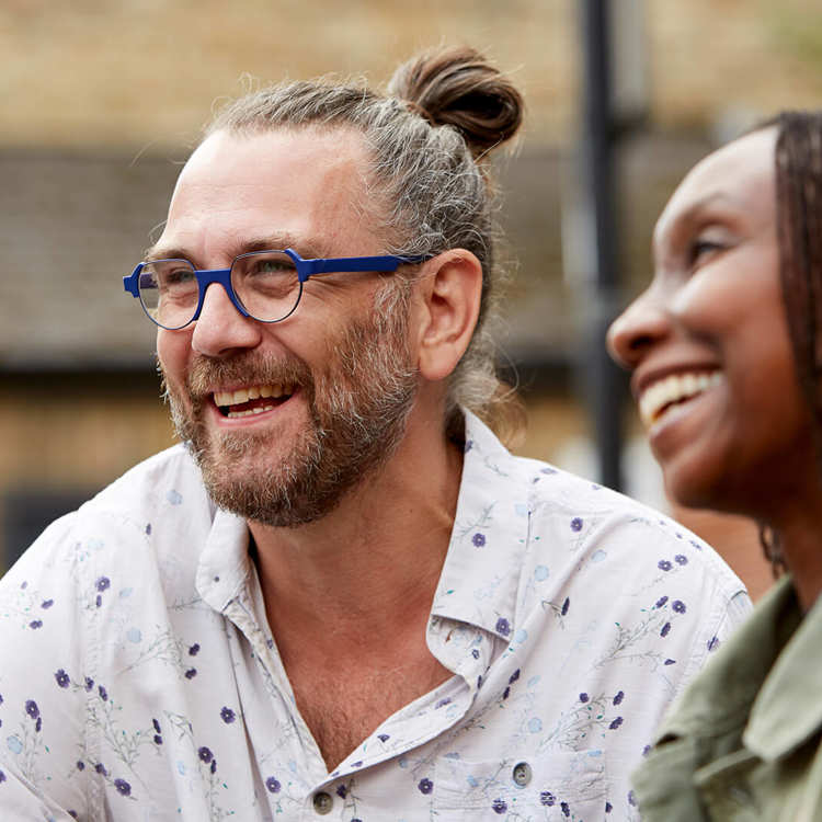 A happy couple laughing together outdoors